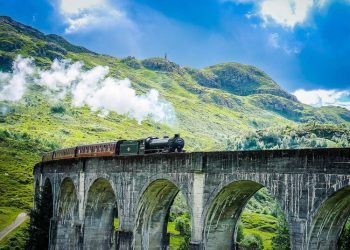 vonat megy at a viadukton a hegyeken